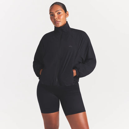 NikeSKIMS STRETCH NYLON OVERSIZED TRACK JACKET | OBSIDIAN
