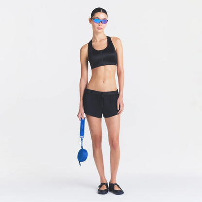NikeSKIMS STRETCH NYLON RUNNER SHORT | OBSIDIAN